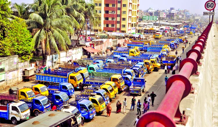 Truck owners illegally occupying the major portion of the main thoroughfare as 'Truck stand'. But the authorities concern or DSCC did not pay any heed to clear the illegal parking. This photo was taken from Kazla area in the city on Friday.