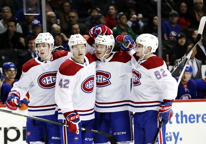 Montreal Canadiens' Artturi Lehkonen (right) celebrates with Noah Juulsen (second from right) Byron Froese (second from left) and Mike Reilly (left) after Juulsen scored a goal during the third period of the team's NHL hockey game against the New York I