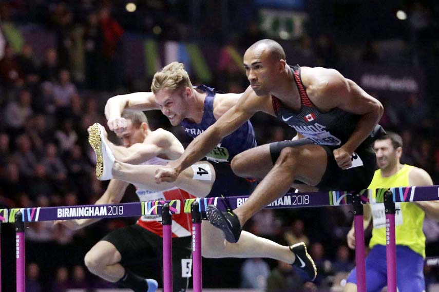 France's Kevin Mayer (center) and Canada's Damian Warner (right) compete in the men's 60 meters hurdles race of the heptathlon at the World Athletics Indoor Championships in Birmingham, Britain on Saturday.