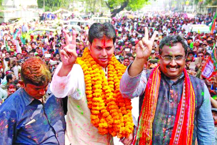 Tripura BJP President Biplab Kumar Deb along with the party's National General Secretary Ram Madhav celebrate the party's performance in the recently concluded Tripura Assembly elections, in Agartala on Saturday.