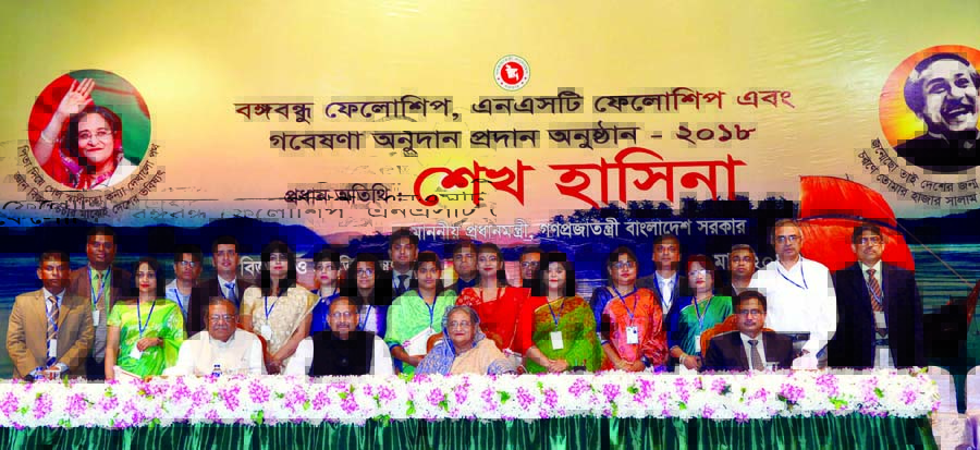 Prime Minister Sheikh Hasina poses for a photograph after distributing Bangabandhu Fellowship, National Science and Technology (NST) Fellowship and special donation for research among post-graduate students studying at different institutions at home and a