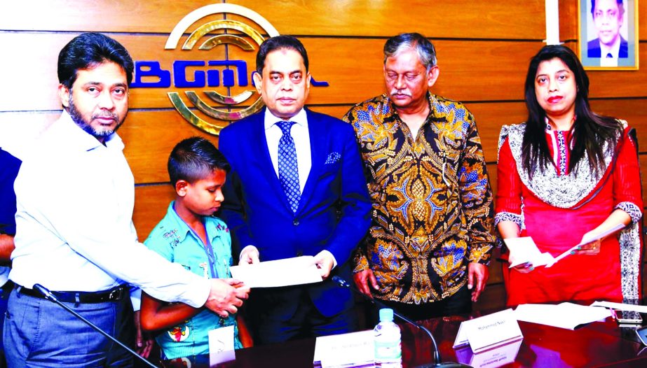 BGMEA President Md. Siddiqur Rahman handing over cheques of group insurance to the nominees of 30 workers and employees of ready-made garment factories those who died during their service at its office in the city on Sunday. Mohammed Nasir, Vice-President