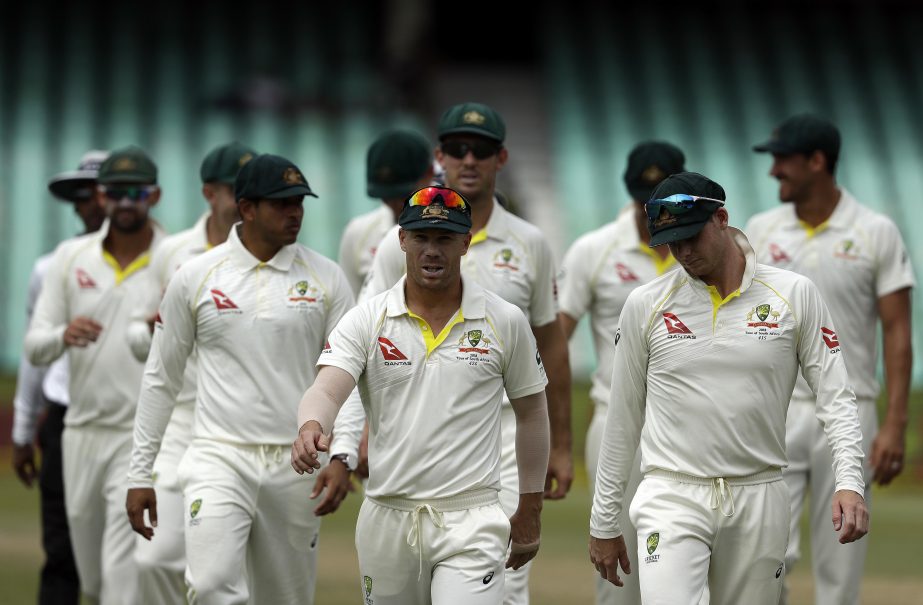 Australia's David Warner, center, leaves the field with teammates at the end of the fifth and final day of the first cricket Test match between South Africa and Australia at Kingsmead stadium in Durban, South Africa, Monday. Australia beat South Africa b