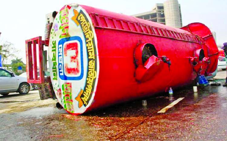 An oil tanker of Meghna Petroleum overturned after driver lost control of the vehicle in city's Ashkona area on Monday.