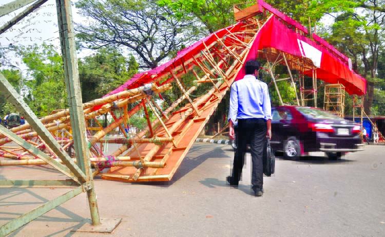 The dismantled main gate (entrance) of Ekushey Boi Mela at Bangla Academy still remains in front of Bangla Academy. Though the Boi Mela ended a week ago, authorities did not remove it causing sufferings to the movement of vehicles and commuters. This phot