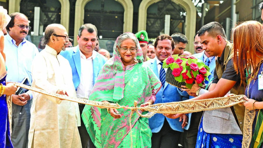 Prime Minister Sheikh Hasina being presented a rose made with jute fabrics when she inaugurated jute products fair at Bangabandhu International Conference Center in the city on Tuesday on the occasion of National Jute Day.BSS photo