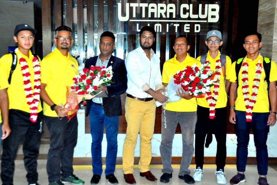 The Officials of Uttara Club Limited receiving the members of Malaysian Tennis team with bouquet in front of Uttara Club Limited in the city on Wednesday.