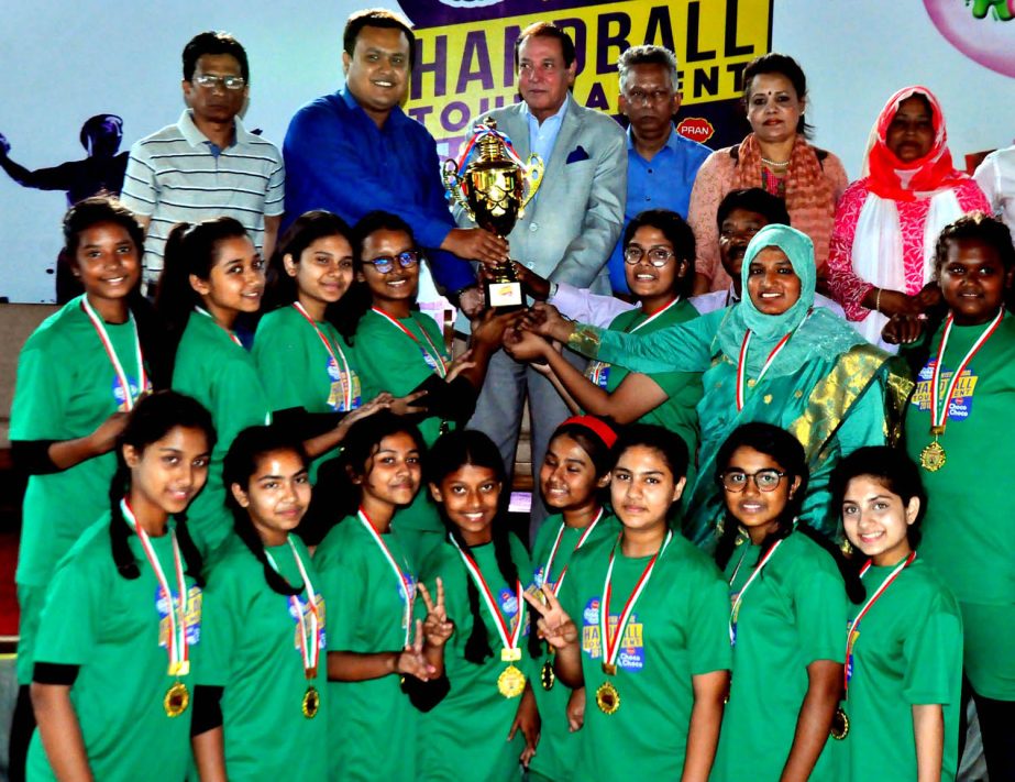 Members of Viqarunnisa Noon School & College, the champions of the Girls' Division of the Bubble Gum Under-14 School Handball Tournament with the chief guest Syed Shahed Reza, the Secretary General of Bangladesh Olympic Association and the other guest an