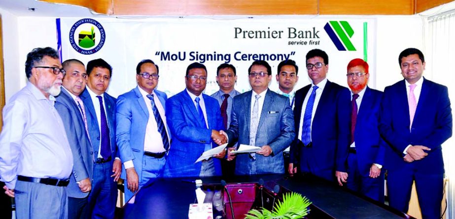 M. Shahdat Hossain (Taslim), Secretary General of Hajj Agencies Association of Bangladesh (HAAB) and M. Reazul Karim, Managing Director of Premier Bank Limited, exchanging a MoU signing documents at HAAB office in the city recently. Under the deal, HABB m