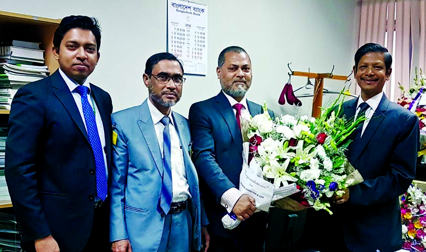 Mamun-Ur-Rashid, Managing Director of Standard Bank Limited (SBL), congratulating Ahmed Jamal, on being appointed as Deputy Governor of Bangladesh Bank at his office in the city recently. Syed Anisur Rahman, Head of International Division of SBL among ot
