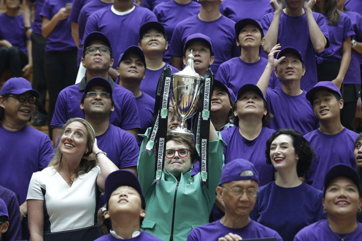 Billie Jean King, founder of the Women's Tennis Association (WTA) and former World No. 1 professional tennis player lifts the WTA challenge trophy named after her at an event organized by WTA to launch the last edition of the WTA Finals in Singapore, bef