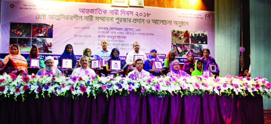 Chief Engineer of LGED Abul Kalam Azad poses for photograph along with the recipients of prizes for the self-reliance in LGED auditorium in the city at a ceremony held recently marking International Women's Day.