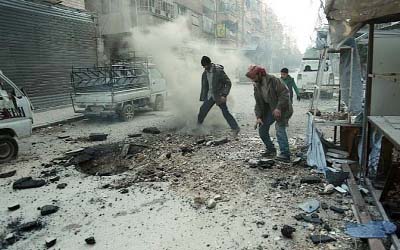 Syrian men check the damage following Syrian government shelling on the town of Douma in the rebel-held enclave of Eastern Ghouta on the eastern outskirts of the capital Damascus on Saturday.