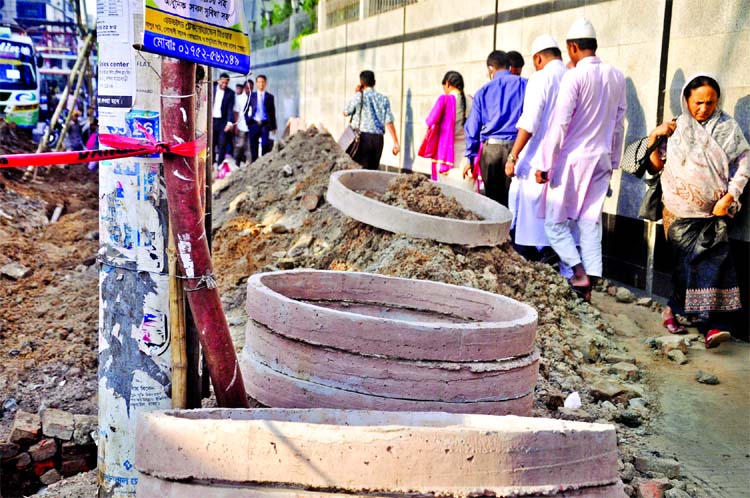 The busy thoroughfare adjacent to Bangladesh Bank at Motijheel area is in sorry state due to digging for utility services but the authorities concern did not remove the soil, causing sufferings to pedestrians and movement of vehicles as well. This photo