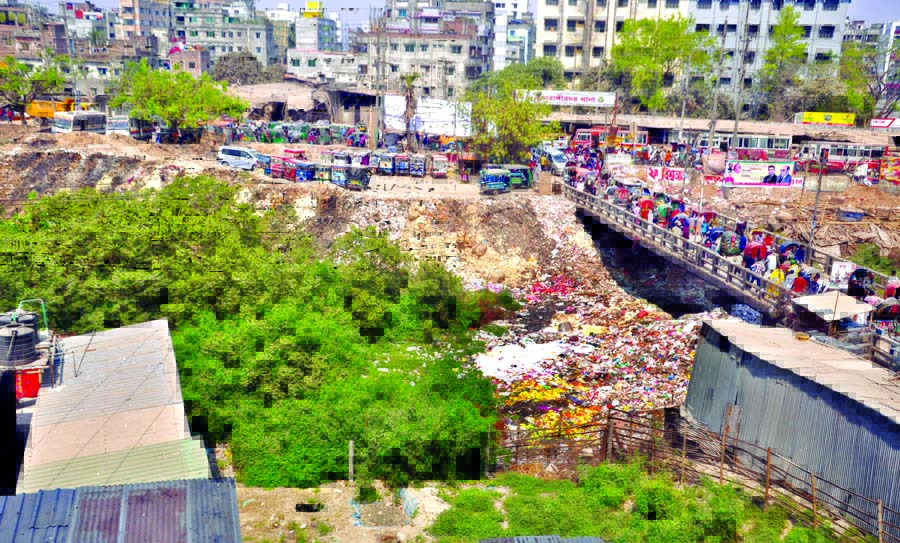 Encroachers occupying a major portion of tributaries of Buriganga River at Kamrangir Char by dumping sands and turning the space into parking place illegally. This photo was taken from Rasulpur area on Sunday.