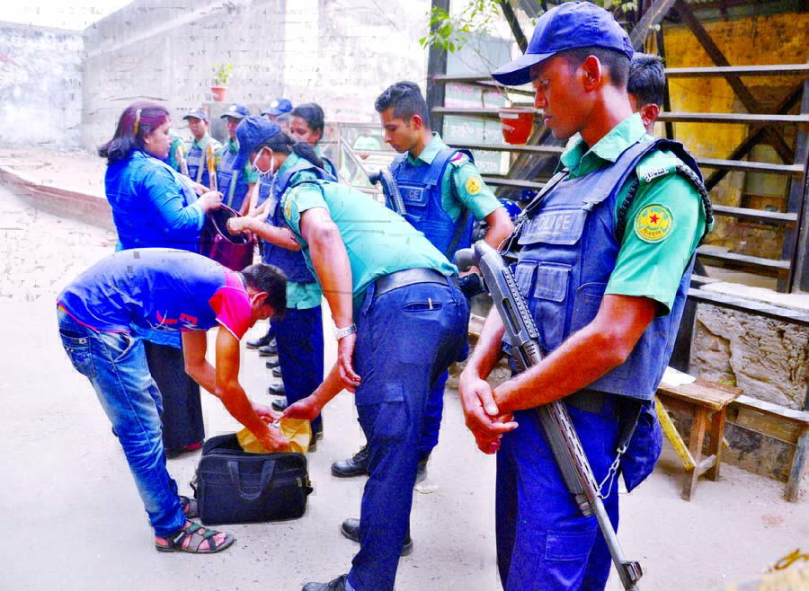 Law enforcers engaged in checking people of Nazimuddin Road adjacent to the Old Dhaka Central Jail when they come out of their residences for work after BNP Chairperson Begum Khaleda Zia was sent to jail. The snap was taken on Monday.