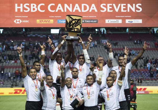 Fiji players celebrate with the trophy after defeating Kenya to win the World Rugby Sevens Series final in Vancouver, British Columbia on Sunday.