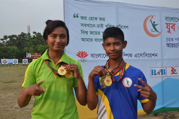 Rabeya Khatun (left) and Mishad Prodhan pose for photo with their individual gold medals of Youth Games Archery event at Ahasan Ullah Master Stadium in Gazipur on Monday.