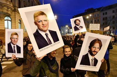 Protesters wave placards with grafittied images of Slovakia's Prime Minister Robert Fico and Interior Minister Robert Kalinak during an anti-government rally in Bratislava.
