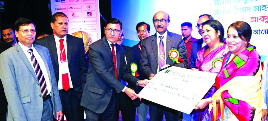 Speaker of the Parliament Dr. Shirin Sharmin Chaudhury, handing over the SME loan cheque of Tk 50 lakh to a women entrepreneur on behalf of Mercantile Bank Limited at 'Bankes-Woman Entrepreneur Conference and Product Exhibition-2018' at Bangladesh Shish