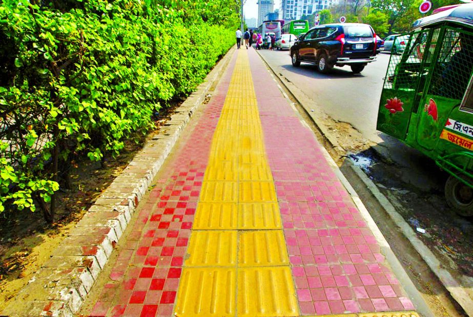 Yellow Stripe being installed over the red stripe in city footpaths for the betterment of visually impaired persons. This picture was taken from a footpath in city's Bangla Motor area on Tuesday.