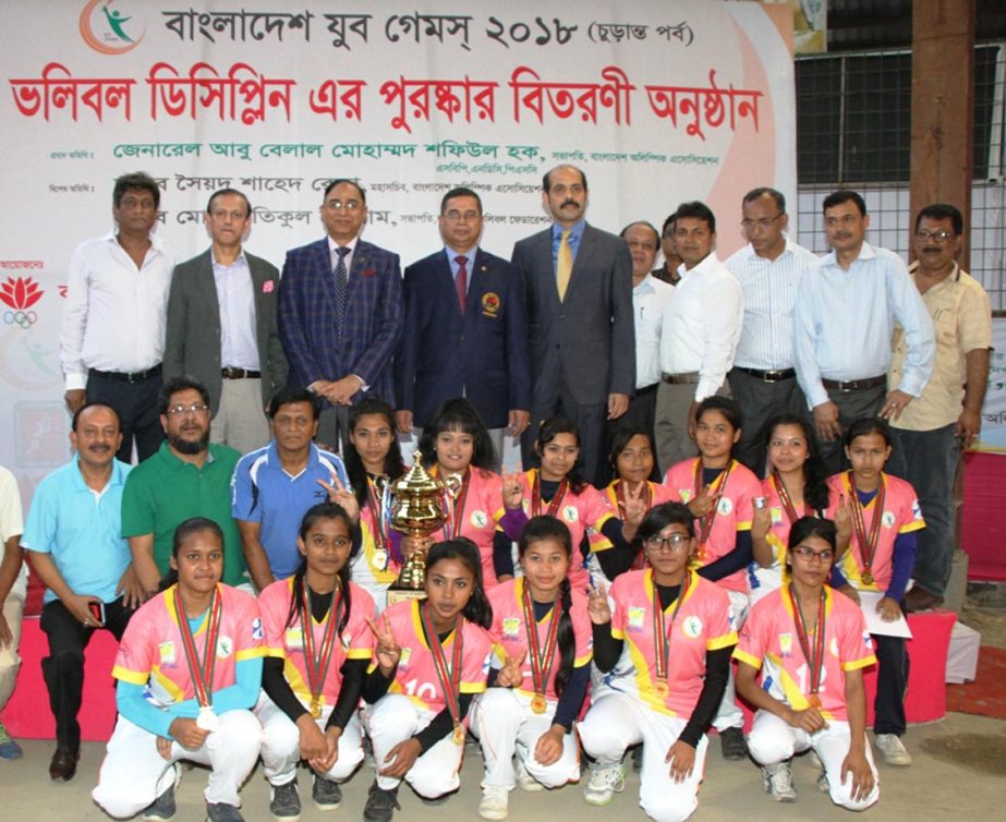 Members of Chittagong Division, the winners of the Girls' Division of the Volleyball Competition of the Bangladesh Youth Games with the guests and officials of Bangladesh Volleyball Federation pose for a photo session at the Volleyball Stadium on Wednes