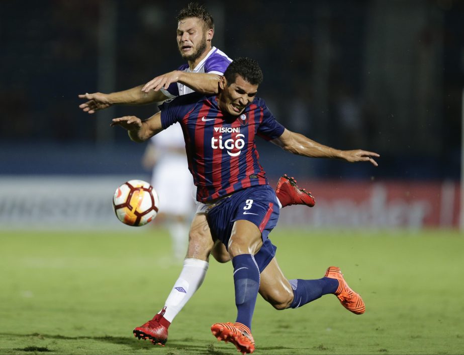 German Rivero (back) of Uruguay's Defensor Sporting fights for the ball with Cristian Insaurralde of Paraguay's Cerro Porteno during a Copa Libertadores Soccer game in Asuncion, Paraguay on Tuesday.