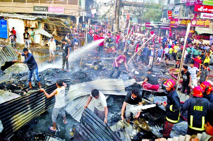 Fire-fighting units trying to douse the flame as devastating fire that broke out at Khilkhet kitchen market in city on Wednesday.