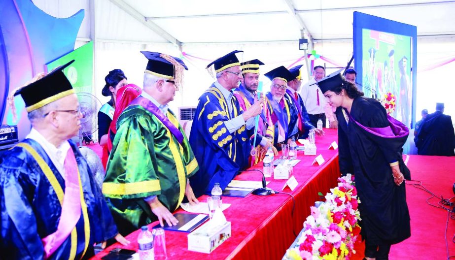 Education Minister Nurul Islam Nahid confers medal to a female graduate in the 4th convocation of Northern University Bangladesh (NUB) on its permanent campus in the capital's Ashkona on Wednesday.