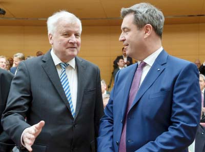 The provocative comments by Seehofer, seen here on the left, come just two days after Merkel was sworn in for a fourth term with a new right-left "grand coalition". government.