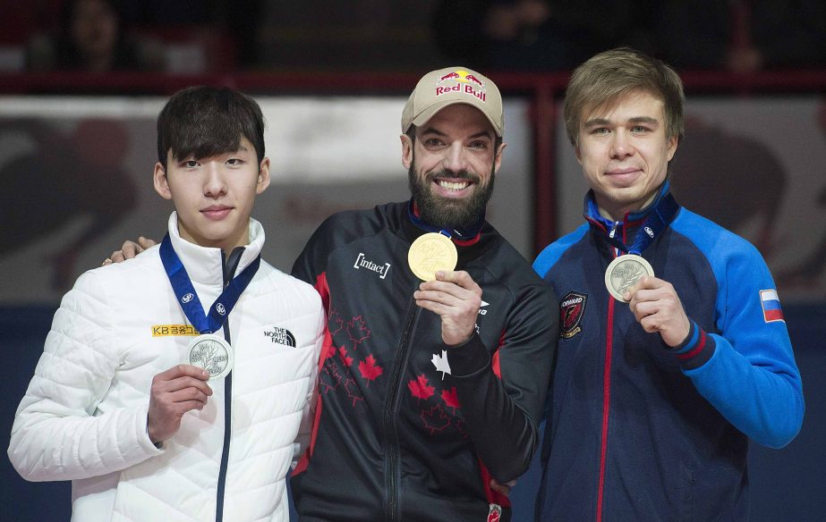 From left : Lim Hyo-jun of South Korea (silver), Charles Hamelin of Canada (gold) and Semion Elistratov of Russia (bronze) hold up their medals following the men's 1,500 meters at the ISU world short-track speedskating championships in Montreal on Satur