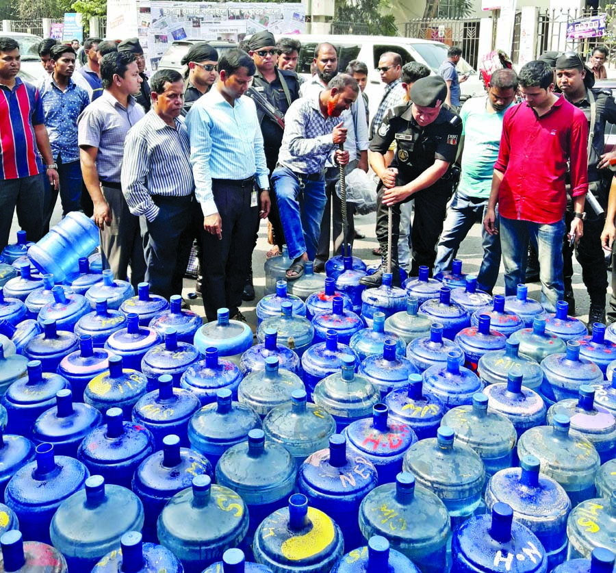 About 4200 plastic water jars being destroyed, collected from 5 illegal factories, sealed two and realises Taka four lakh for marketing contaminated waters in city. Nine persons also sent to jail on different terms. This photo was taken from Shilpakala Ac