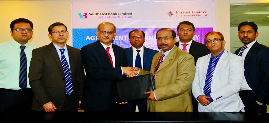 S M Mainuddin Chowdhury, AMD of Southeast Bank Limited and Santanu Saha, Managing Director of Fareast Finance and Investment Limited, exchanging an agreement signing documents at its head office in the city recently. Under the deal, the bank will provide