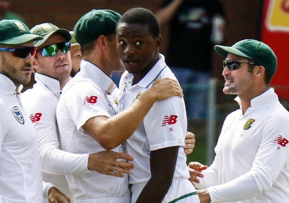 FILE -- In this March 9, 2018 file photo South Africa's bowler Kagiso Rabada (second right) celebrates a wicket with teammates during the second cricket Test match between South Africa and Australia at St George's Park in Port Elizabeth, South Africa. R