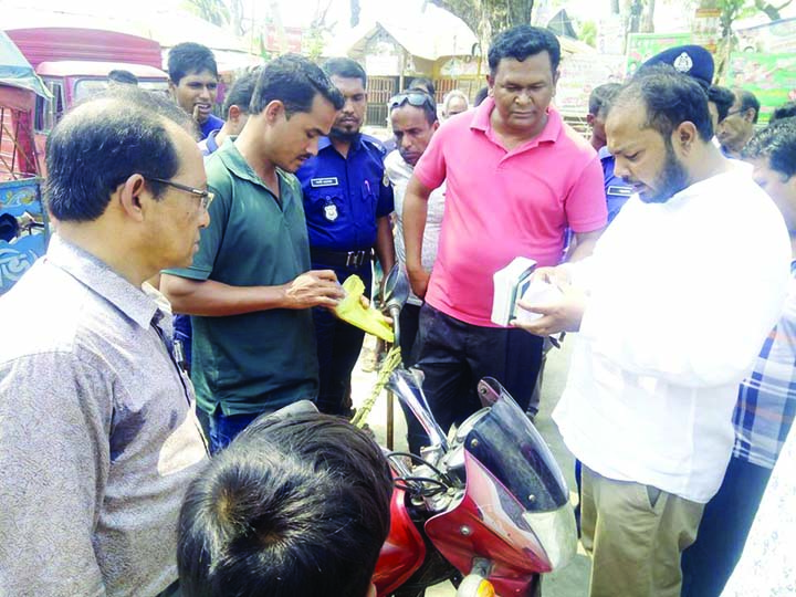 BETAGI (Barguna): Members of mobile court checking a motor cycle at Betagi Poura Town on the occasion of the World Consumers' Day recently .