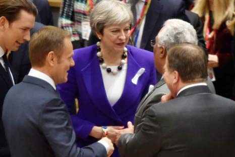British Prime Minister Theresa May talks with Portuguese Prime Minister Antonio Costa as they attend a European Union leaders summit in Brussels, Belgium, on Thursday.