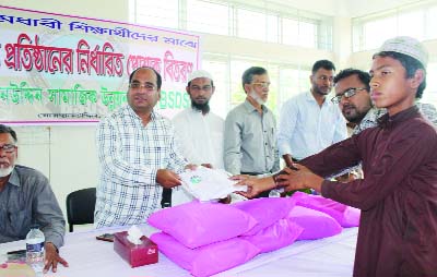 BHOLA: Mayor of Borhanuddin Municipality Md Rafiqul Islam distributing school dresses among the poor students at Muktijoddha Complex in Borhanuddin of Bhola district organised by Borhanuddin Samajik Unnayan Sogstha (BSUS) recently.