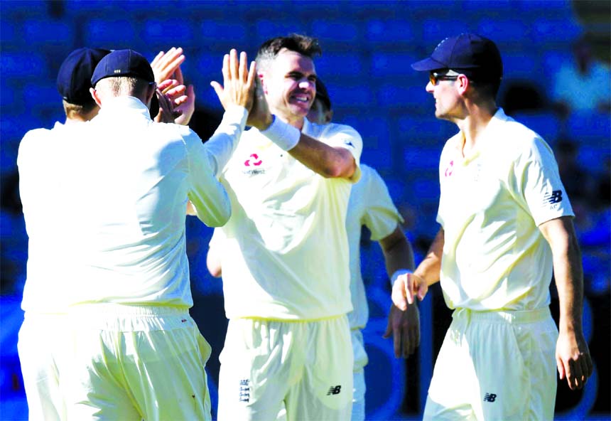 England's James Anderson (centre) celebrates the dismissal of New Zealand's Jeet Ravel for 3 during the first cricket test in Auckland, New Zealand on Thursday.