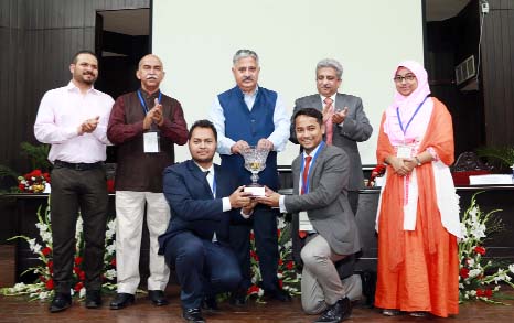 Prof Ashok Aima, Vice Chancellor of Central University of Jammu hands over the Champion Trophy to the winning 'PediCare' team members of Daffodil International University at International Business Plan Competition-2018 held in Jammu University of India