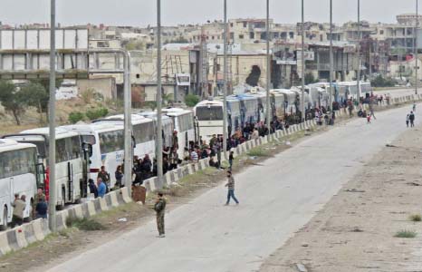 Hundreds of rebel fighters and civilians from Harasta in Syria's Eastern Ghouta board buses on Friday in an evacuation deal as a Russian-backed regime assault comes close to recapturing full control of the region.