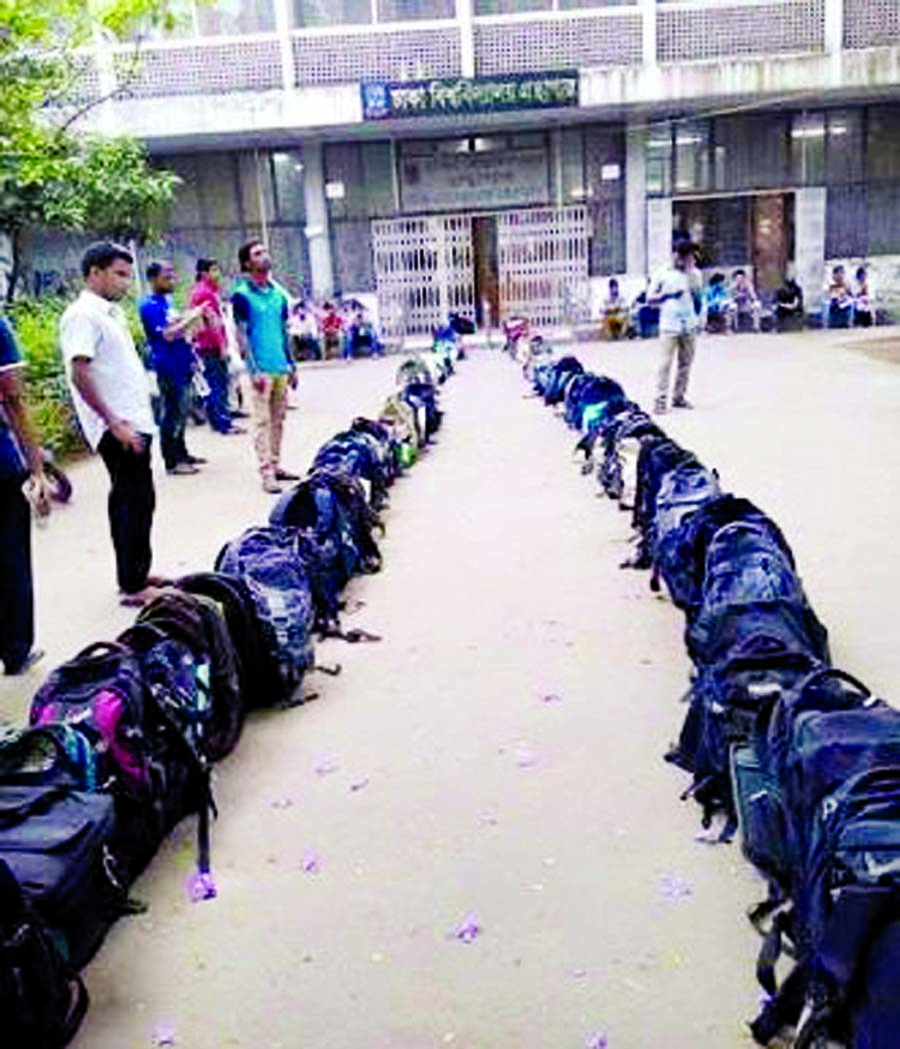 Students of Dhaka University put their bags in queue in front of the Central Library of the university with a view to getting chance for entering the library. The snap was taken from the spot recently.