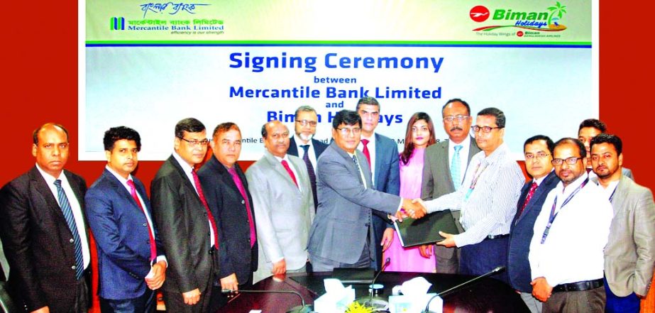 Md. Abu Sakin, Head of Card Division of Mercantile Bank Limited and Md. Shawkat Hossain, DGM of Biman Bangladesh Airlines, exchanging an agreement signing documents at the bank's head office in the city on Thursday. Under the deal, Biman Holidays (a wing