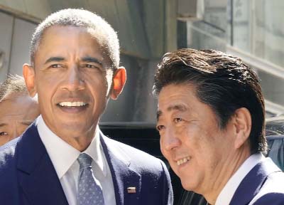 Former US president Barack Obama (L) is greeted by Japan's Prime Minister Shinzo Abe before the pair have lunch.
