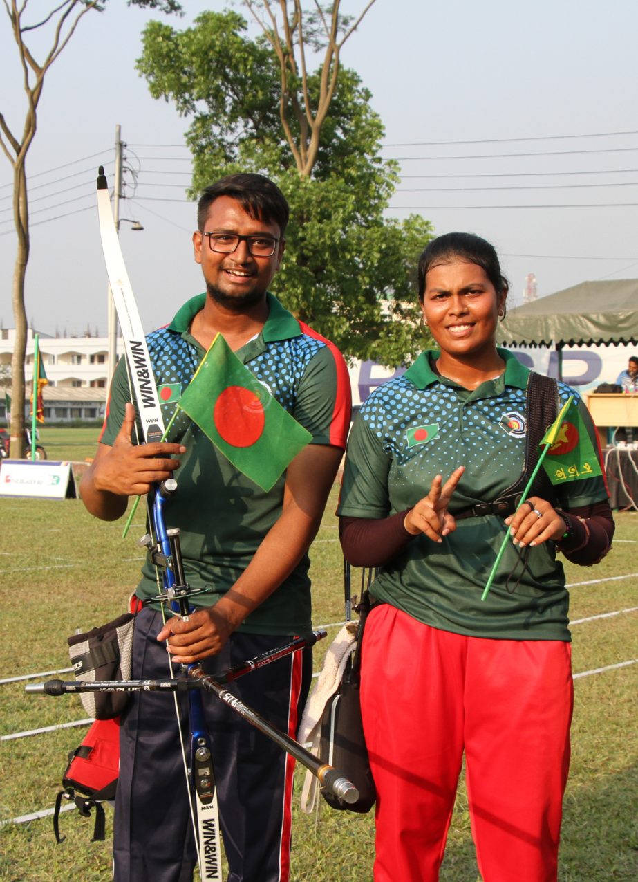 Md Rumman Sana of Bangladesh (left) and his compatriot Nasrin Akter pose for photo after reaching the final of their respective Recurve singles of the Blazer BD BKSP 3rd South Asian Archery Championship at the BKSP Ground in Savar on Sunday.