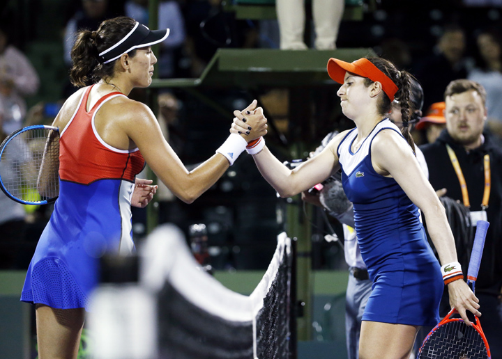 Garbine Muguruza (left) of Spain and Christina McHale of the United States, meet at the net after a Miami Open tennis match on Saturday in Key Biscayne, Fla. Muguruza won 6-2, 6-1.