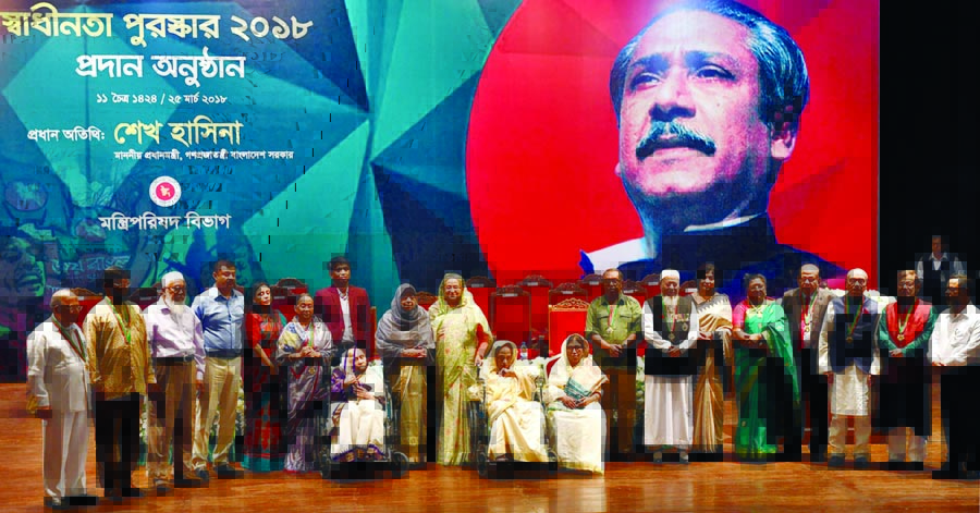 Prime Minister Sheikh Hasina poses at a photo session with the recipients of Independence Day Award 2018 at Osmani Auditorium on Sunday. BSS: Photo