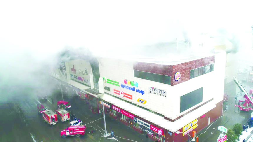 Smoke raises over a shopping center Zimnaya Vishnya in the West Siberian city of Kemerovo, Russia on early Monday.