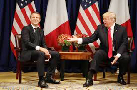 Macron (L) laughs with Trump before a meeting at the Palace Hotel during the 72nd session of the United Nations General Assembly in New York.