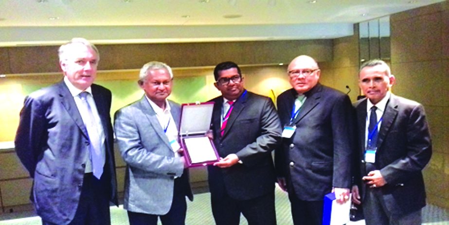 Md. Rezaul Karim, Chairman of Shippers' Council of Bangladesh and Vice-Chairman of Asian Shippers' Alliance, handing over a crest to Chrisso de Mel, Chairman of Sri Lankan Shippers' Council at a function in Hong Kong recently. Denis Choumert, Chairman