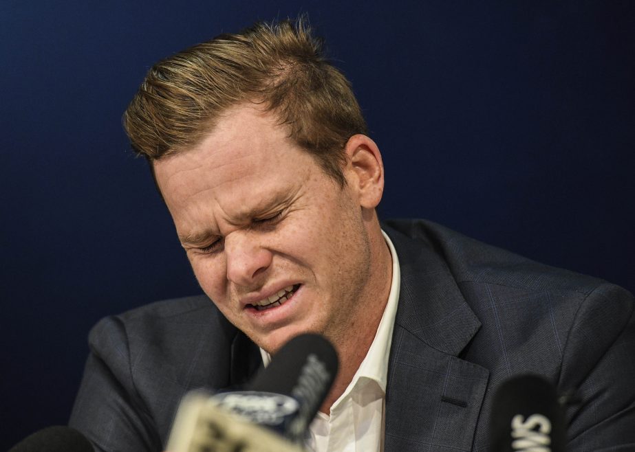 Australian Cricket Captain Steve Smith reacts during a press conference at Sydney International Airport in Sydney on Thursday.